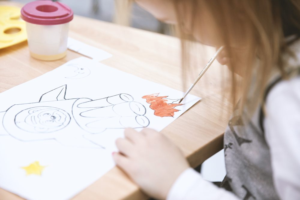 A BEA student working on a creative coloring activity